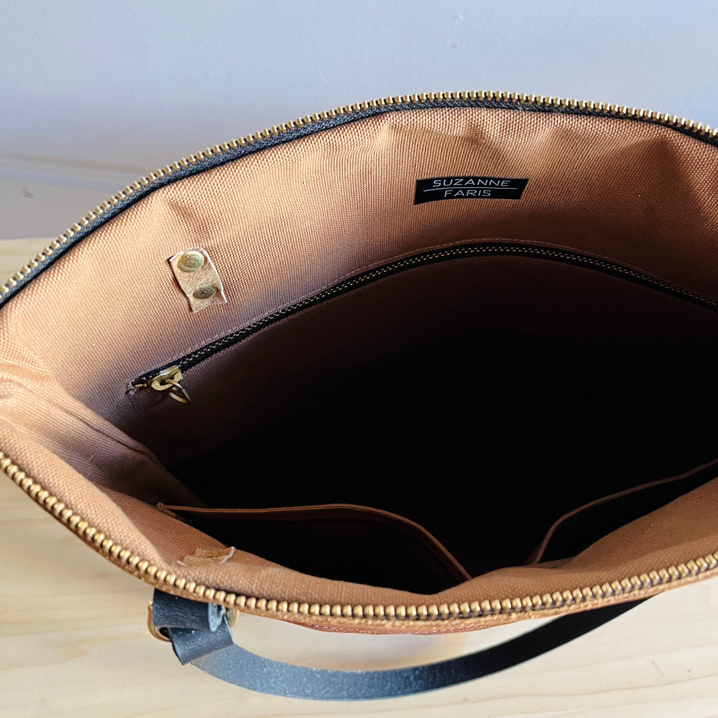 brown interior on cognac leather shoulder bag by Suzanne Faris