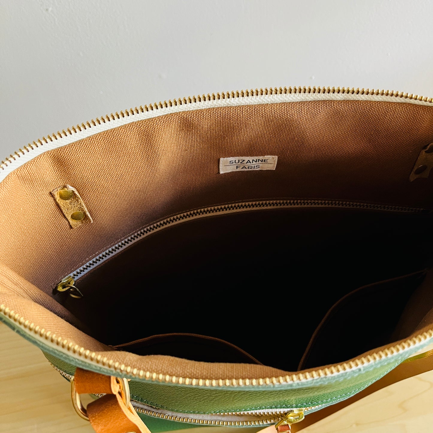 brown interior of moss green leather shoulder bag by suzanne faris