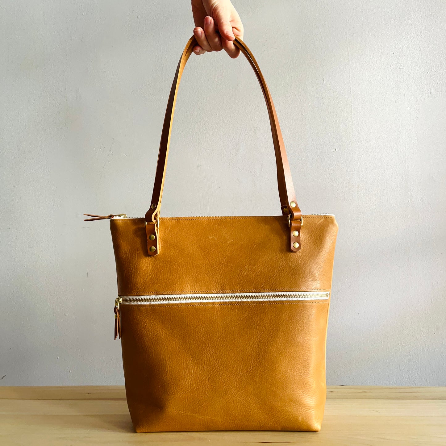 tan leather shoulder bag by Suzanne Faris