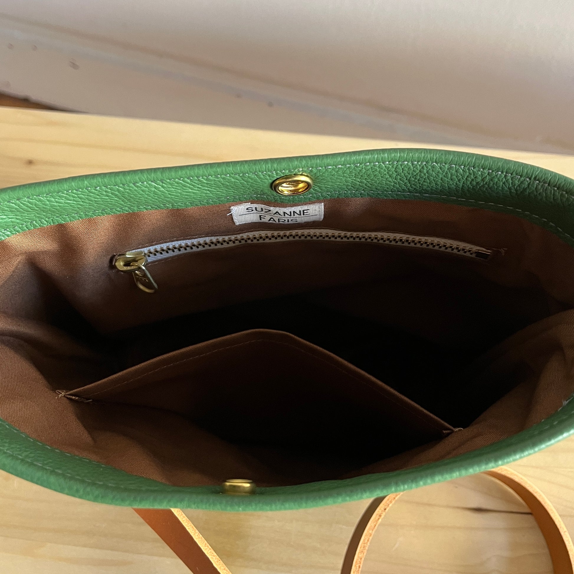 brown leather interior on moss green leather bag