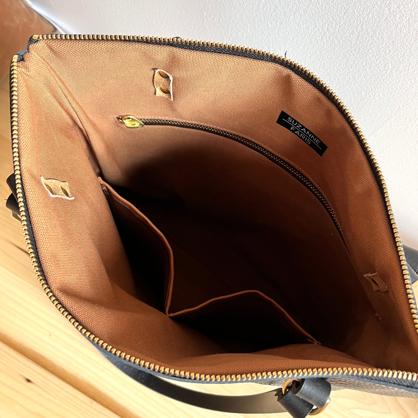 brown interior of black ebony leather shoulder bag